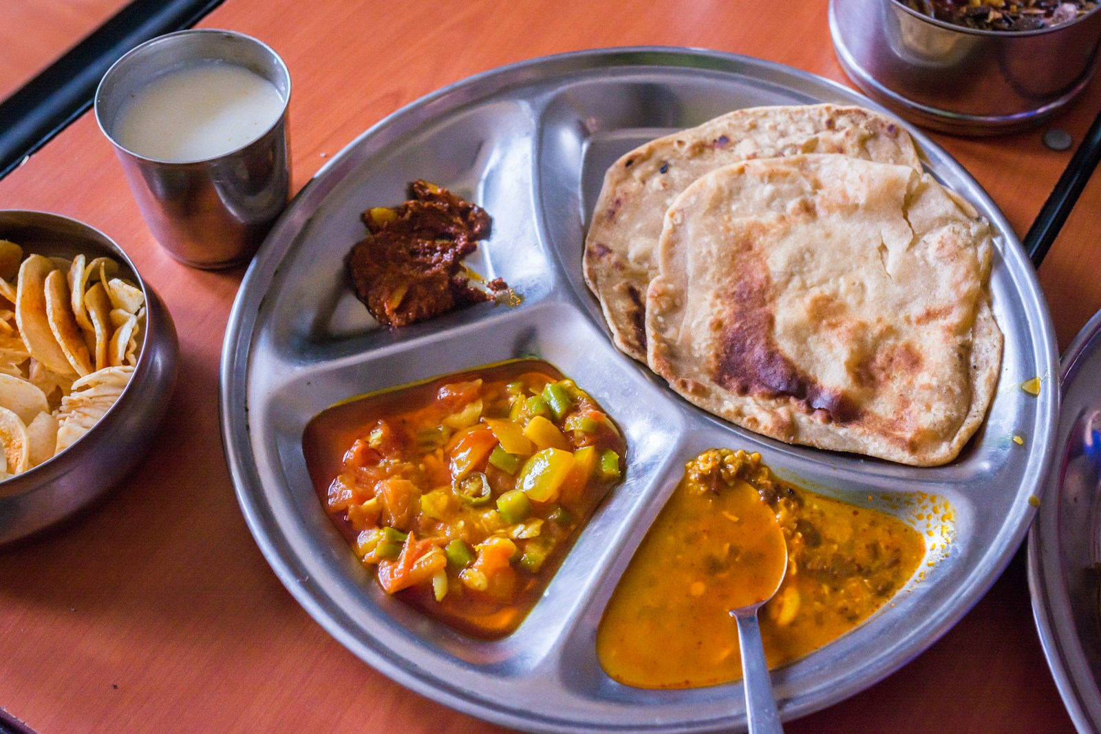 Flatbread served alongside a selection of curries